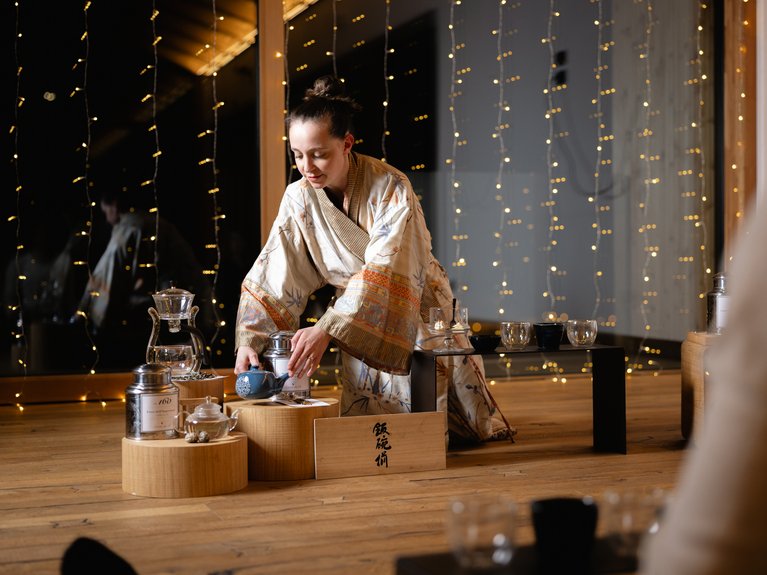 Hotel Latemar mit Dolomitenblick Frau im Kimono bereitet traditionelle japanische Teezeremonie vor