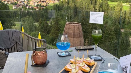 Picture gallery Table with drinks and snacks overlooking mountains and village