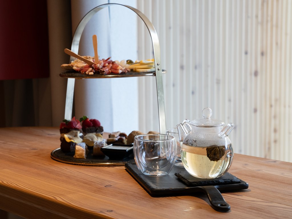 Val di Fassa and cycle track: outside our cocktail & tea bar Tea set with glass teapot and pastries on two-tier tray