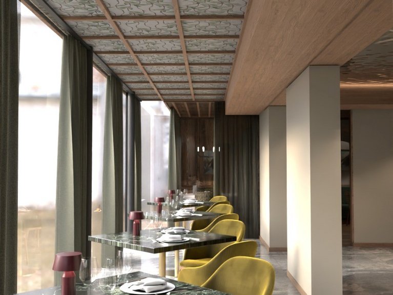 Restaurant Mirage mit Dolomiten-Blick im Fassatal Moderner Speiseraum mit Marmortischen und gelben Stühlen