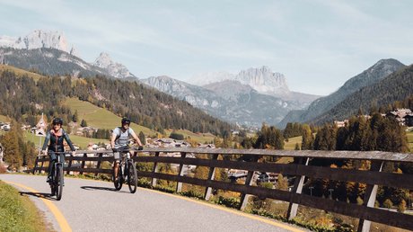 Picture gallery Two people cycling on a mountain road with alpine landscape