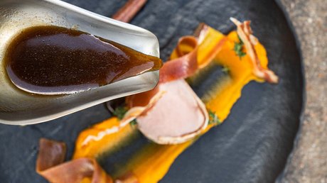 Picture gallery Sauce poured on plate with orange puree and decorated meat