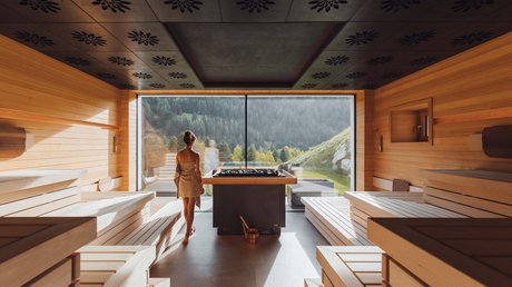 Picture gallery Woman with towel in modern sauna with panoramic mountain view