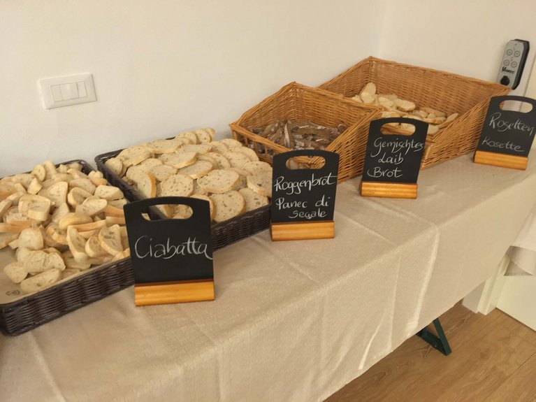 On the webcam Latemar is lovely, in real life it’s a dream! Trays of sliced bread types with labels on tablecloth-covered table