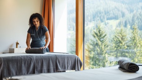 Picture gallery Spa worker arranging towel in room with mountain view