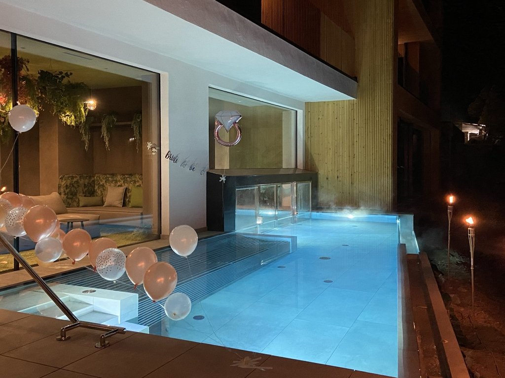 Val di Fassa: wandern, biken, erleben Beleuchteter Pool bei Nacht mit Luftballons und Fackeln für Feier