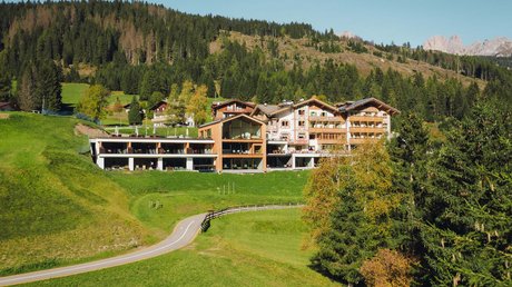 Picture gallery Alpine-style hotel surrounded by green meadows and forests in the mountains