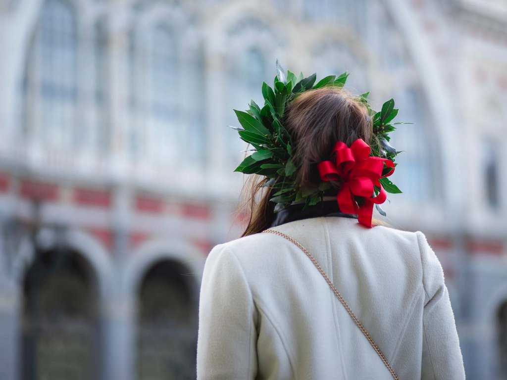 Dalla webcam il Latemar è bello, ma dal vivo è un sogno! Persona con corona di alloro e fiocco rosso vista di spalle